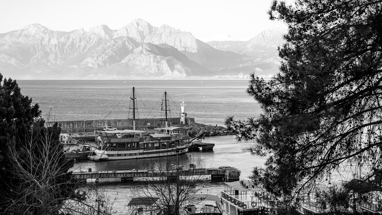 Black and White Coastal View of Antalya Harbor with Mountains