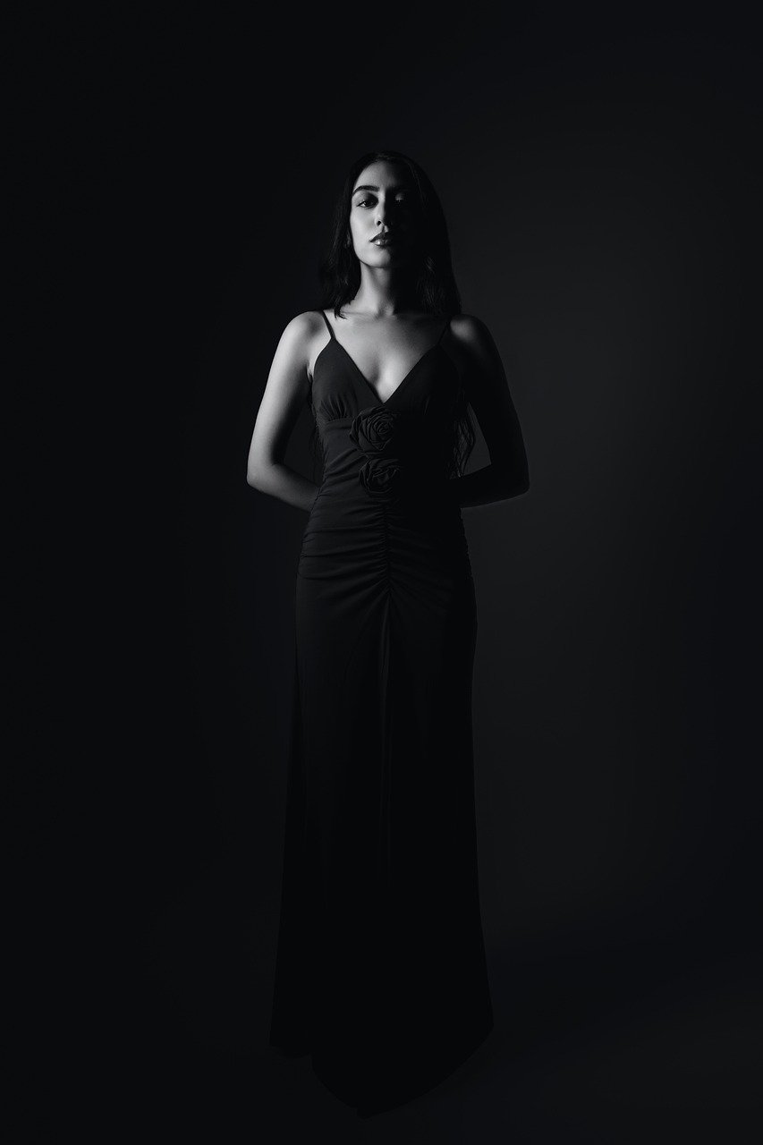 Elegant Woman in Black Evening Gown with Dramatic Lighting