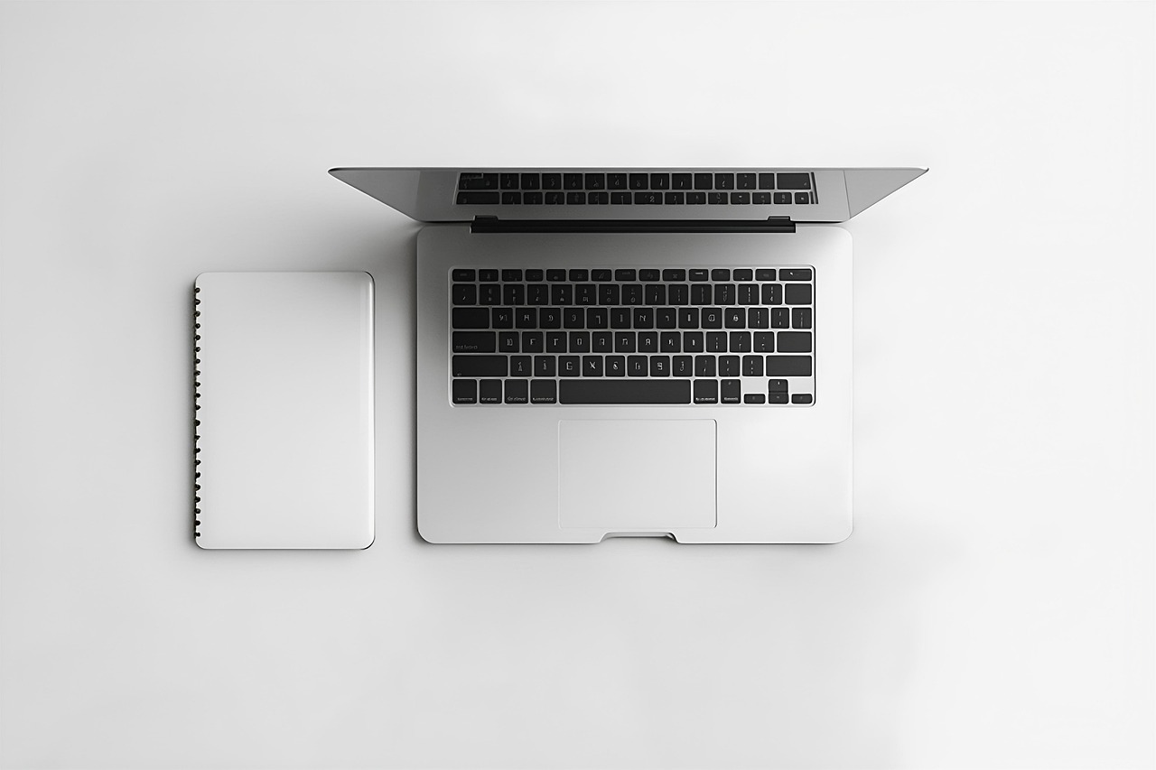 Minimalist Office Setup with Laptop and Notebook