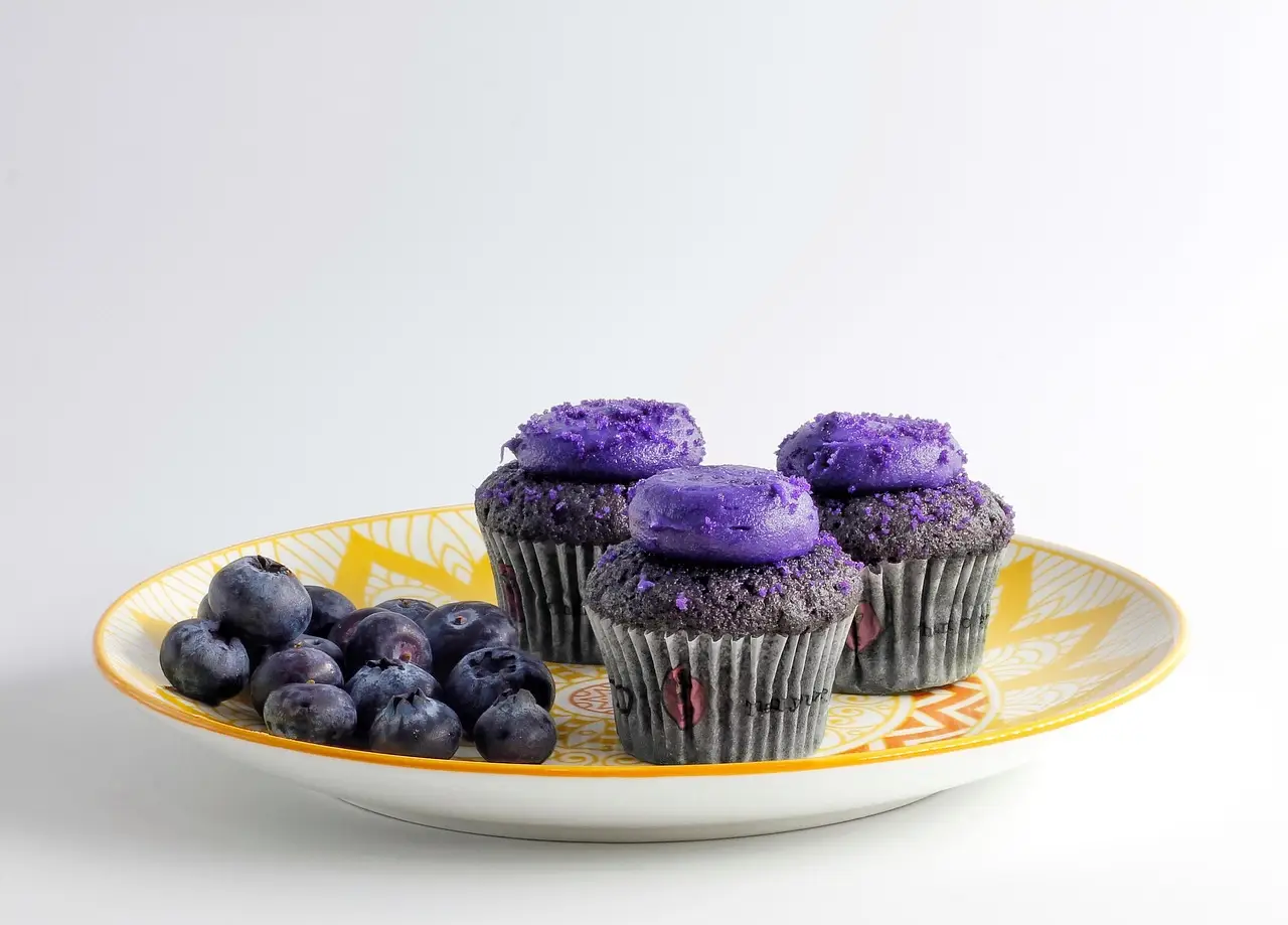 Purple Frosted Cupcakes with Fresh Blueberries on Decorative Plate