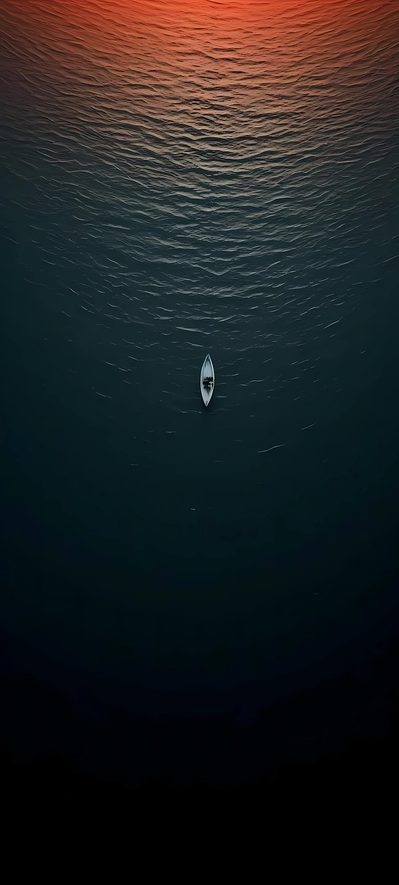 Solitary Boat on Ocean at Sunrise