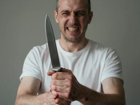 Aggressive Bald Man Holding a Large Knife