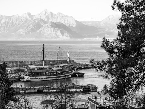 Black and White Coastal View of Antalya Harbor with Mountains