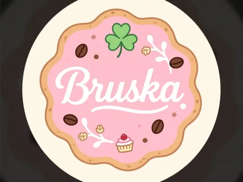 Bruska Cookie Logo with Pink Frosting and Decorative Elements