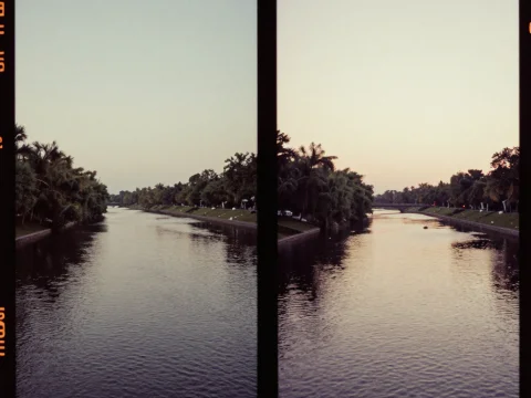 Calm River at Dusk with Tree-Lined Banks