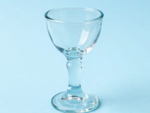 Clear Glass Goblet on Soft Blue Background
