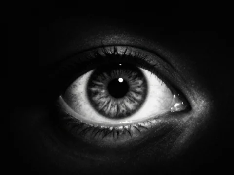 Close-up of a Glowing Eye in Darkness