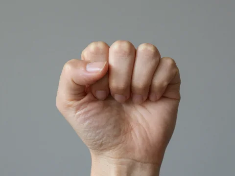 Close-up of Female Hand in Fist Gesture