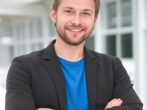 Confident Young Man Smiling with Arms Crossed