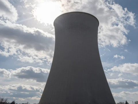 Cooling Tower Silhouette Against Bright Sky