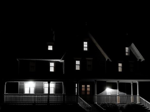Dark Night View of a Lit House with Porch