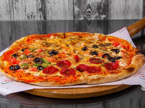 Delicious Pepperoni and Olive Pizza on Wooden Paddle