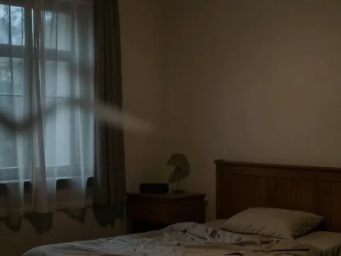 Dimly Lit Empty Bedroom with Flickering Light