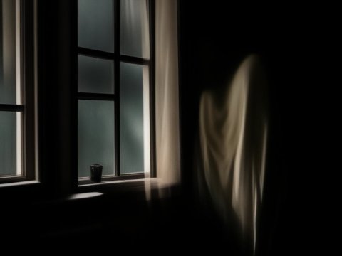 Eerie Ghostly Figure by Window in Dark Room