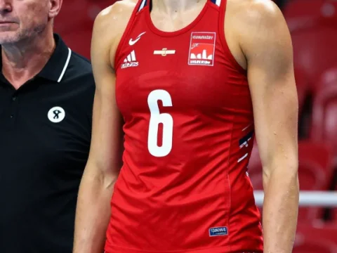 Focused Female Volleyball Athlete in Red Uniform
