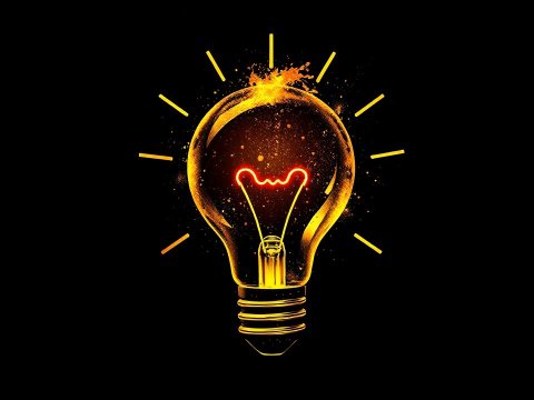 Glowing Light Bulb with Radiant Sparks on Black Background