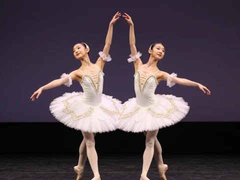 Graceful Ballet Duo in White Tutus on Stage
