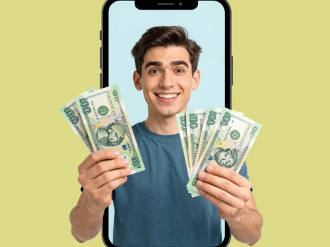 Happy Young Man Holding Money Emerging from Phone Screen