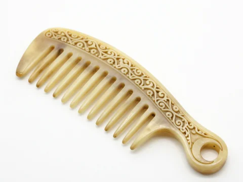 Intricately Carved Bone Comb with Crescent Design