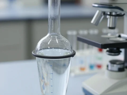 Laboratory Glassware and Microscope in Scientific Setting