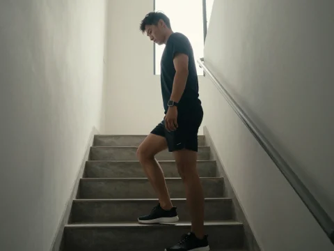Man Descending Stairwell in Morning Light
