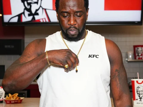 Man in KFC Shirt Holding Sauce Drop