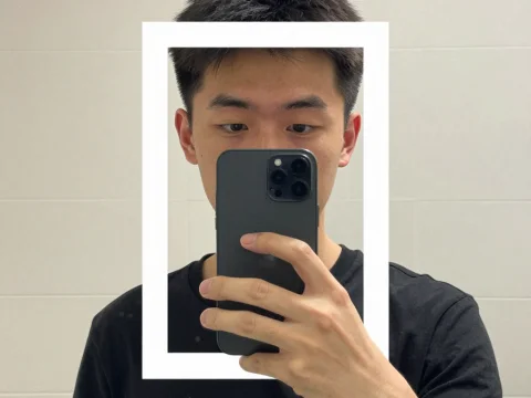 Man Taking a Selfie with Phone in Mirror