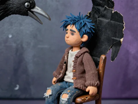 Miniature Figurine of Sad Boy with Crow Wings and Two Crows