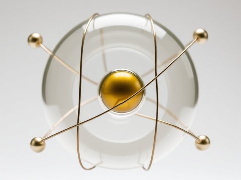 Minimalist Atomic Model with Gold and Glass Elements