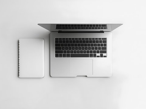 Minimalist Office Setup with Laptop and Notebook