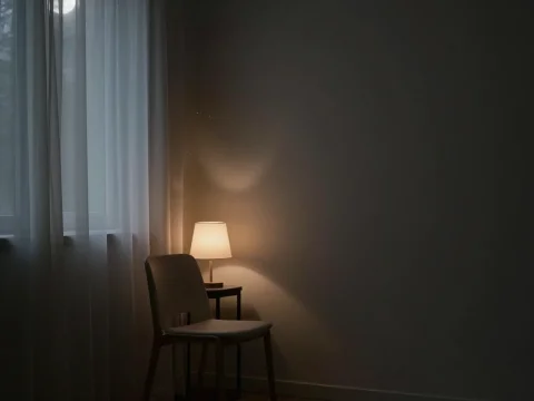 Minimalist Room with Chair and Soft Lamp Light at Night