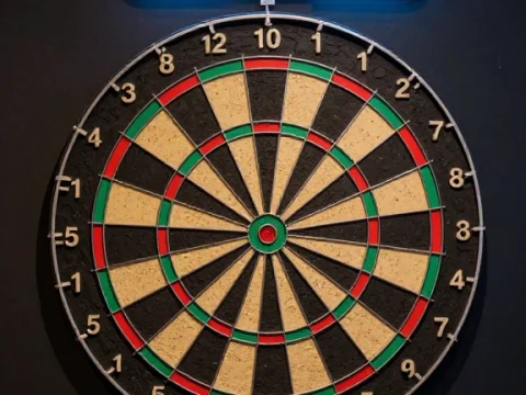 Neon 501 Sign Above Classic Dartboard in Bar