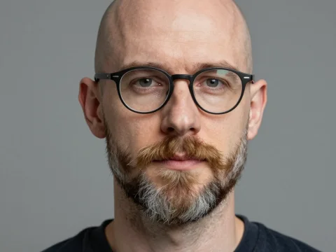 Portrait of a Bald Man with Glasses and Beard