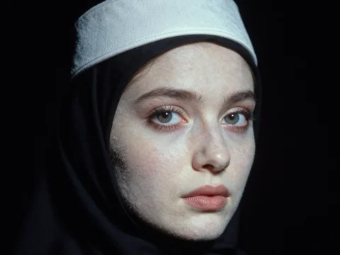 Portrait of a Woman Wearing a White Yarmulke and Black Hijab
