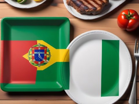 Portuguese and Nigerian Flag Plates with Food on Wooden Table