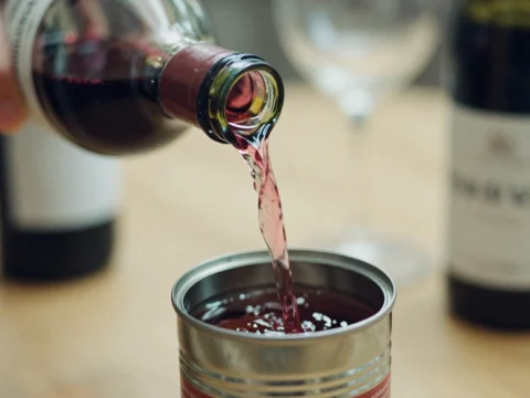 Pouring Red Wine into a Tin Can