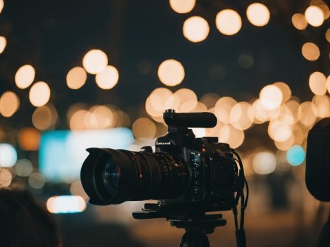 Professional Camera with Bokeh Lights in Background