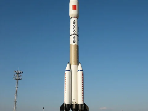 Rocket Standing on Launch Pad Against Clear Blue Sky