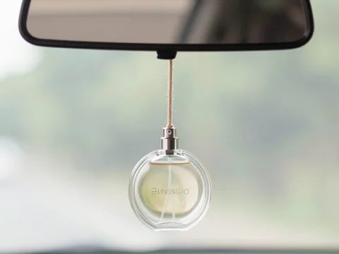 Round Car Perfume Bottle Hanging from Rearview Mirror