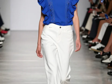 Runway Model in Blue Ruffled Top and White Pants