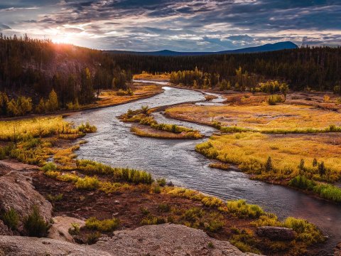 Serene Autumn River at Sunset in Forested Landscape