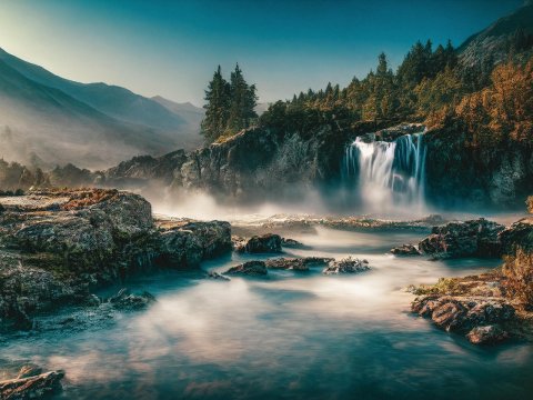 Serene Waterfall and River in a Rocky Forest Landscape