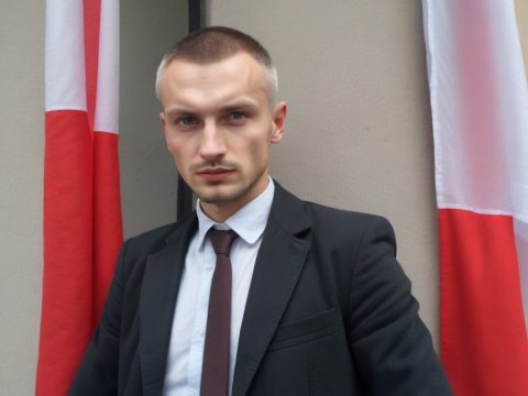 Serious Young Man in Suit with Flags