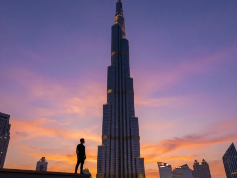 Silhouette of Man Standing Near Burj Khalifa at Sunset
