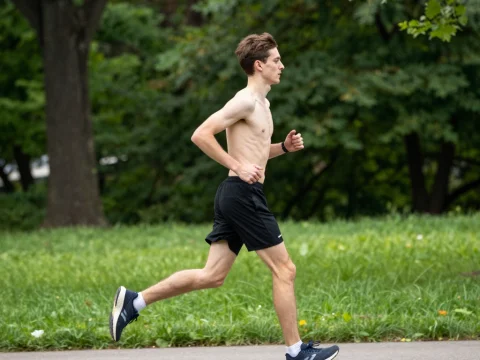Skinny Man Jogging Outdoors in Park