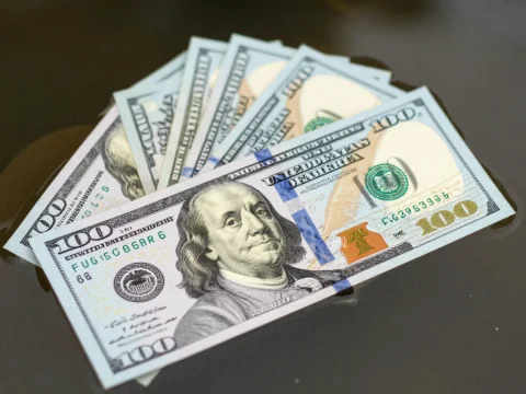 Stack of US 100 Dollar Bills on Water Surface