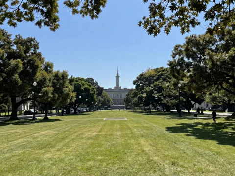 Sunny Day at a Spacious Urban Park with Historic Building
