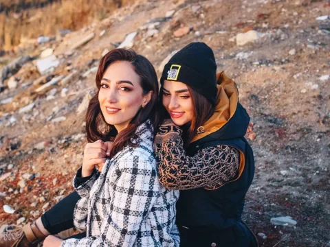 Two Friends Enjoying Outdoors in Casual Winter Wear