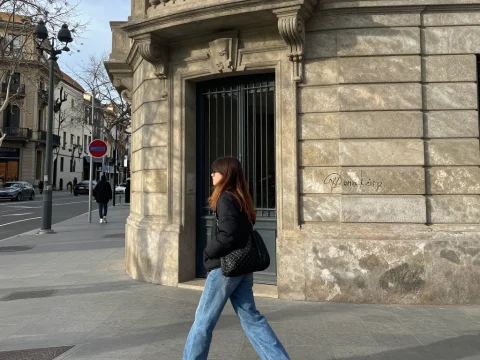 Woman Walking Along Historic Urban Street