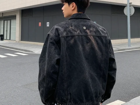 Young Man Wearing Black Denim Jacket on Urban Street